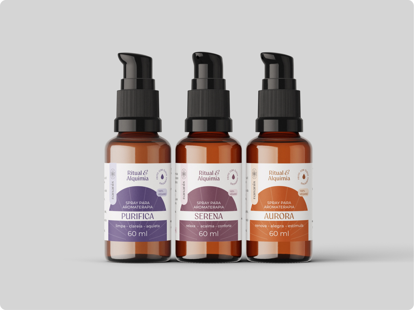 Imagem da linha de cosméticos "ritual de alquia" criado para a marca de aromateratia Nananis. A imagem mostra 3 produtos da linha com rótulos de cores diferentes em frasco ambar.